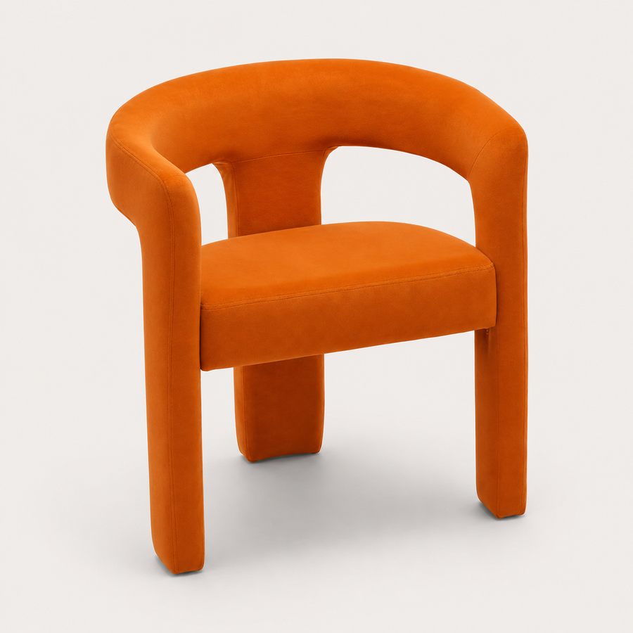 The Clementine Chair in ember-orange velvet with sculptural curved backrest