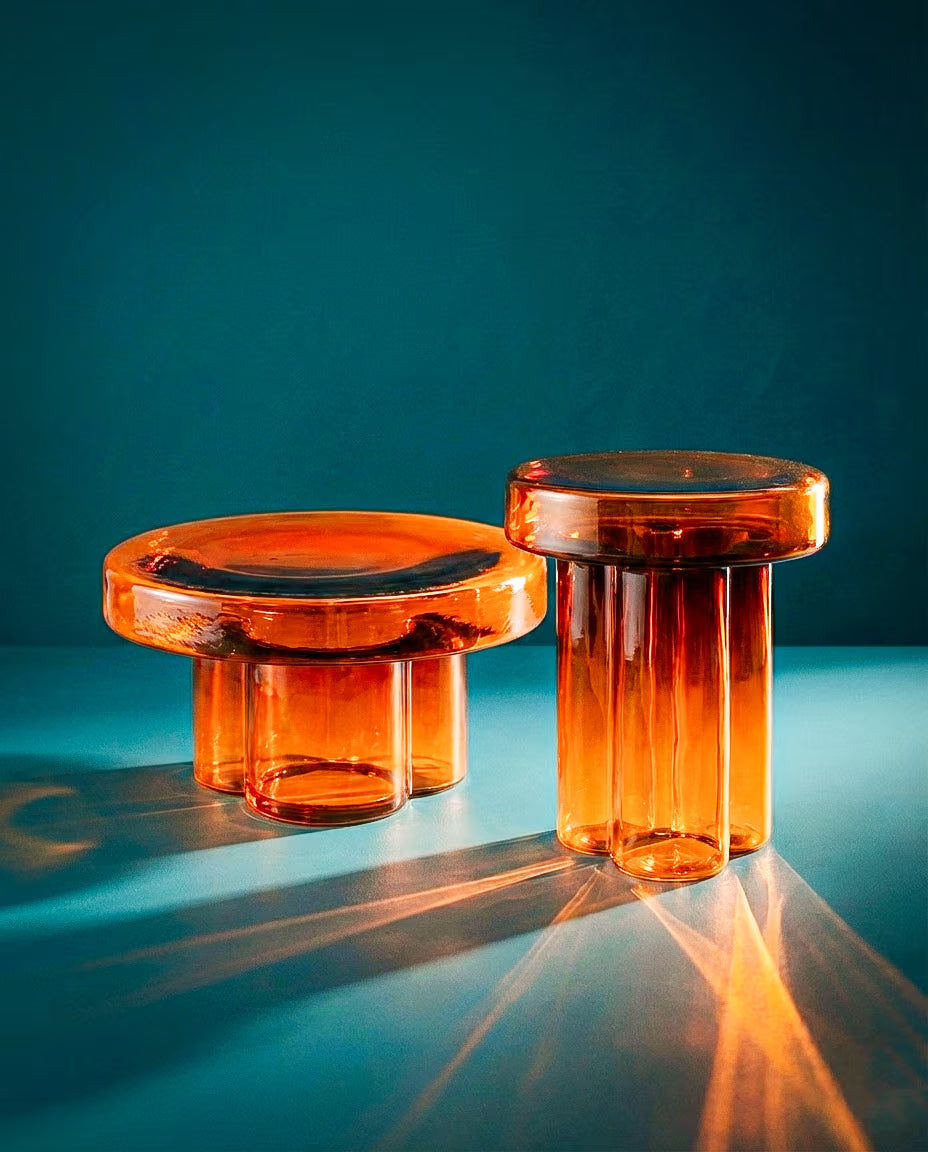 Aperol glass table in an amber-toned finish