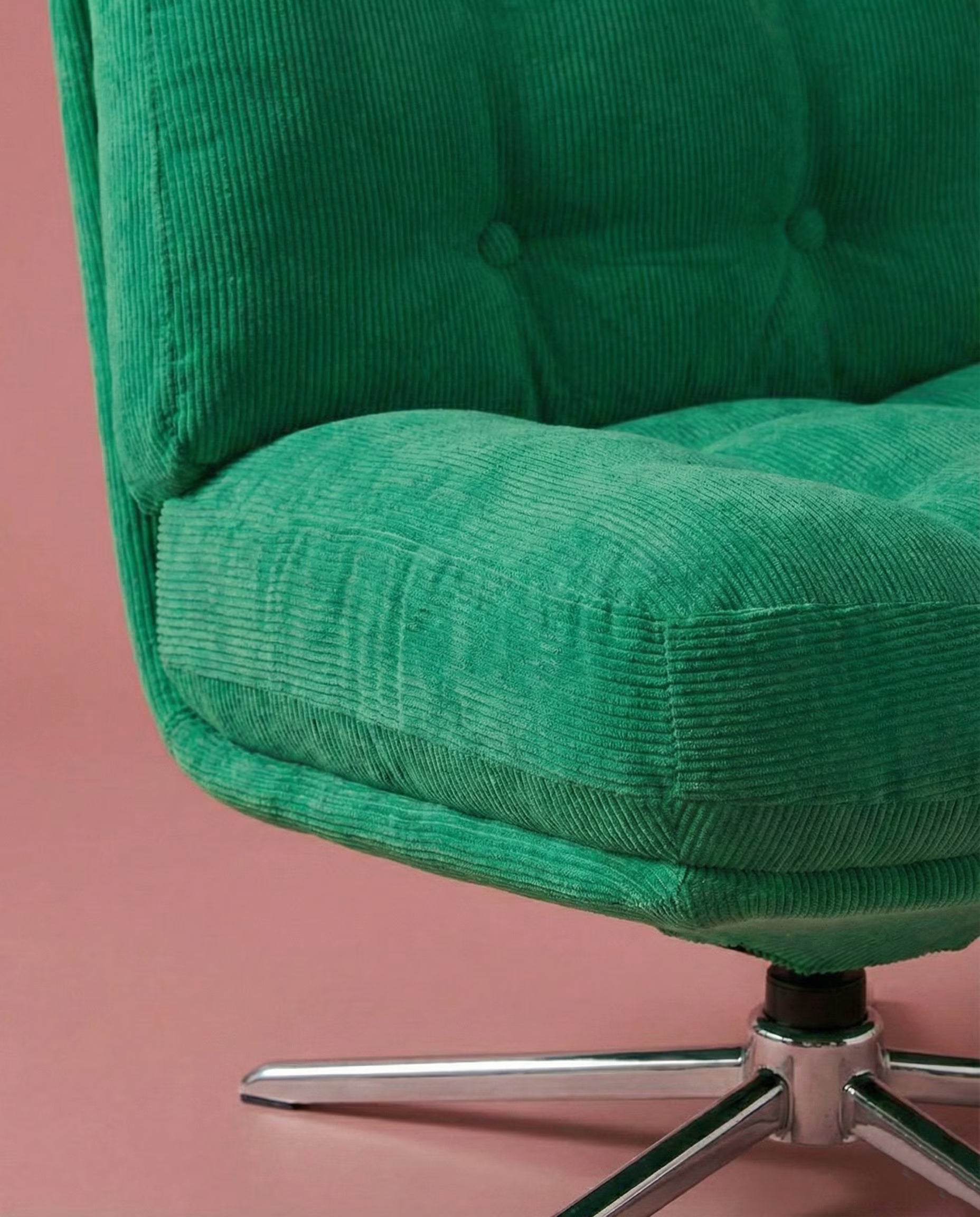 Green corduroy upholstery and electroplated base detail on The Archive Chair
