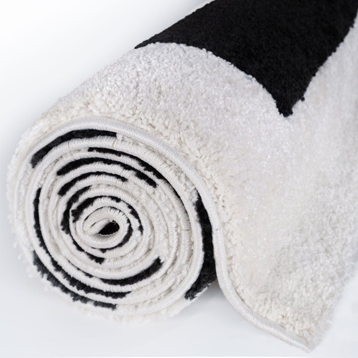 Mono Maze Rug — rolled side view
