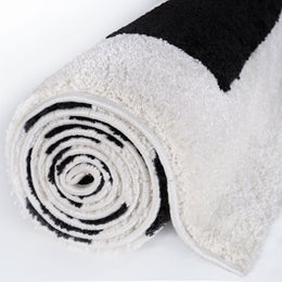 Mono Maze Rug — rolled side view