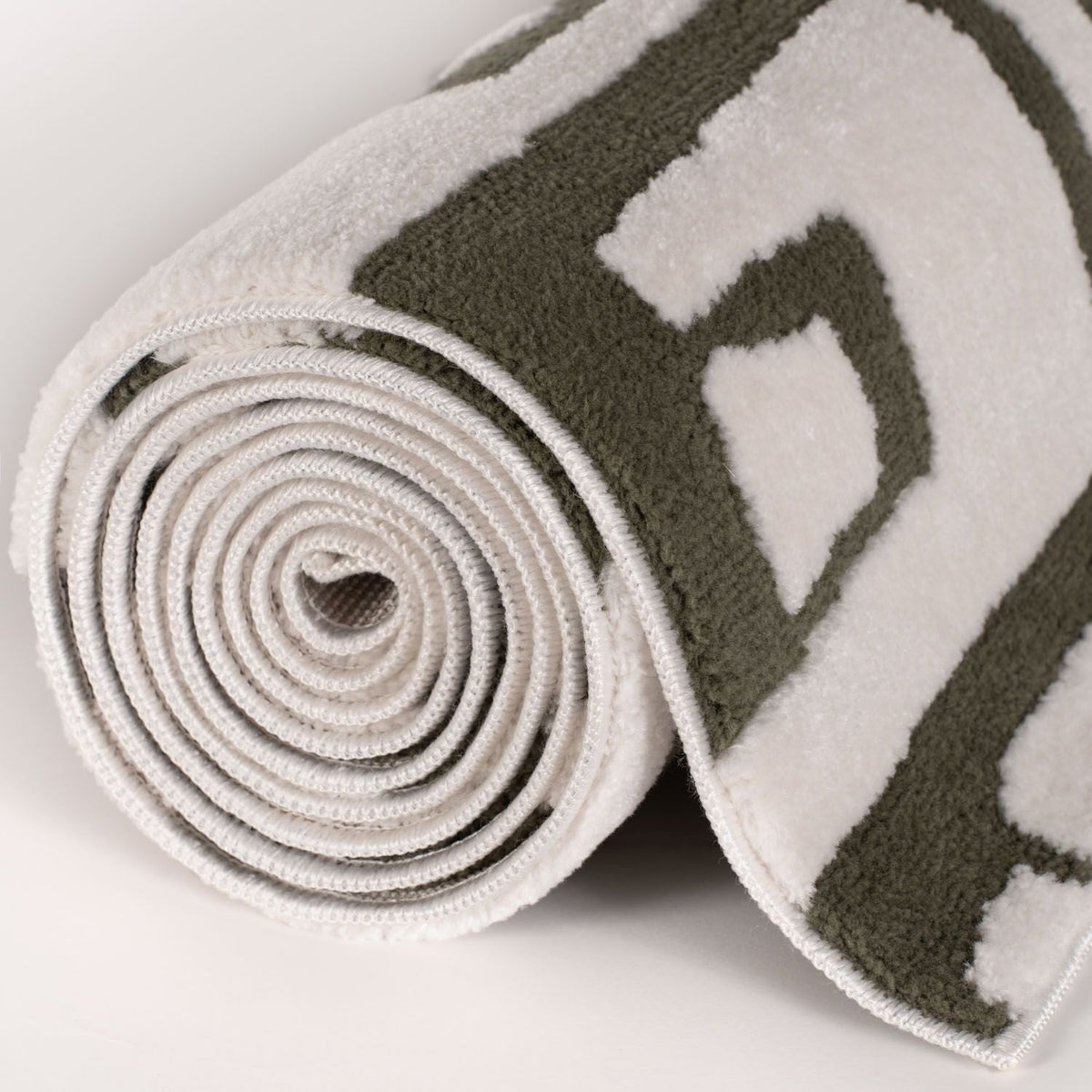 Moss Form Rug — rolled side view