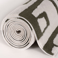 Moss Form Rug — rolled side view