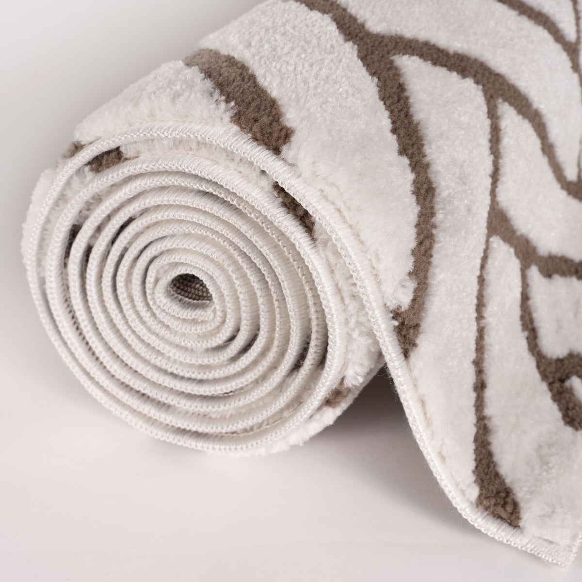 Cocoa Chevron Rug — rolled side view