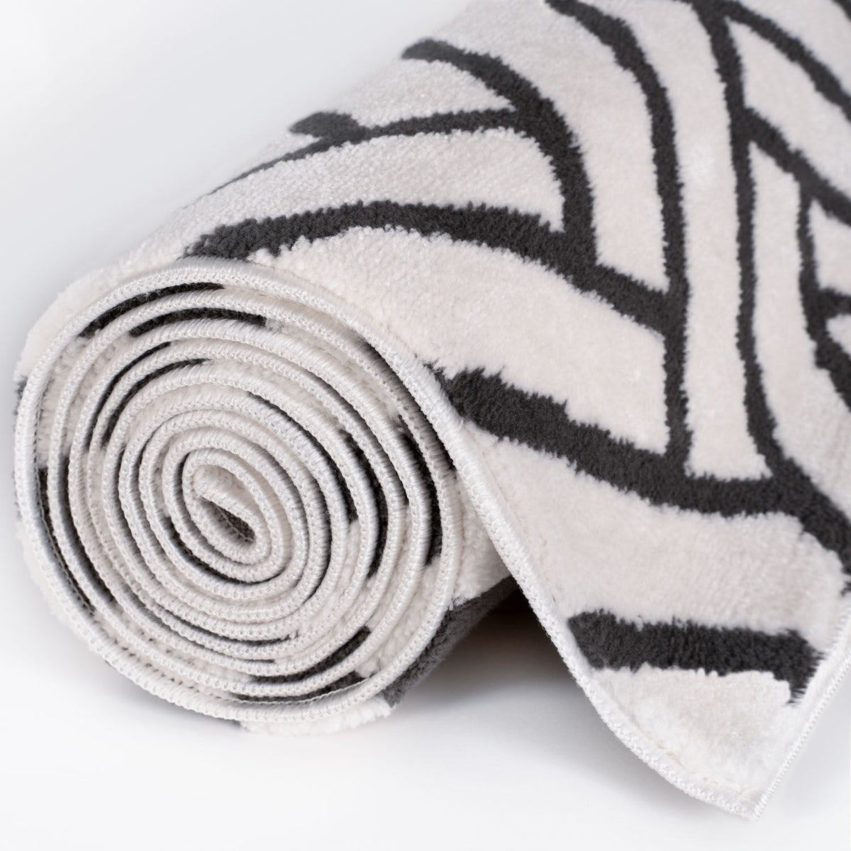 Slate Chevron Rug — rolled side view
