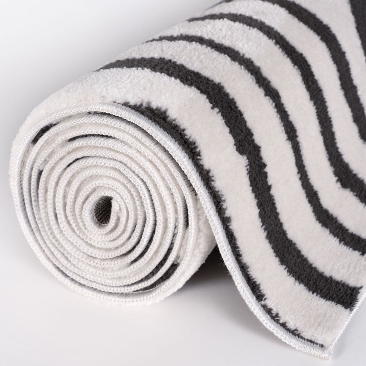 Slate Frame Rug — rolled side view