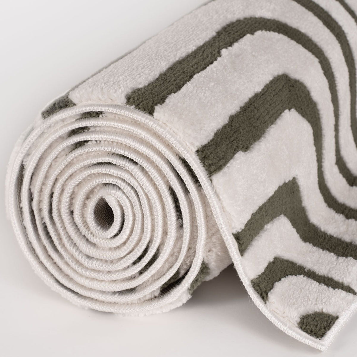 Olive Frame Rug — rolled side view