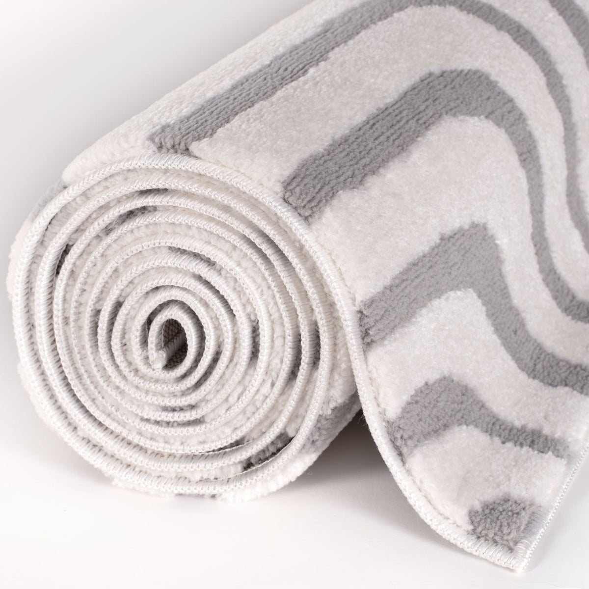 Silver Frame Rug — rolled side view