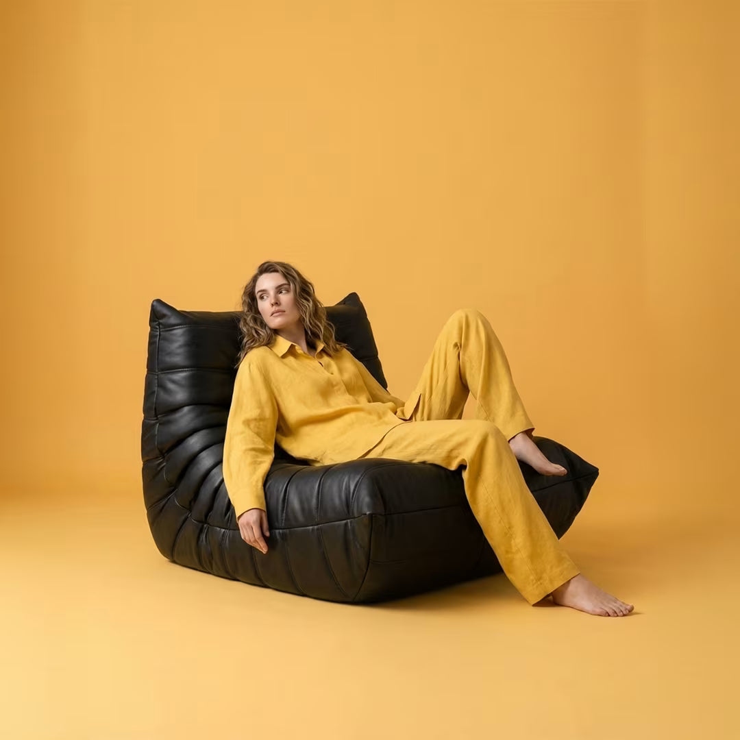 Black PU leather Caterpillar Lounger Chair with segmented cushioning