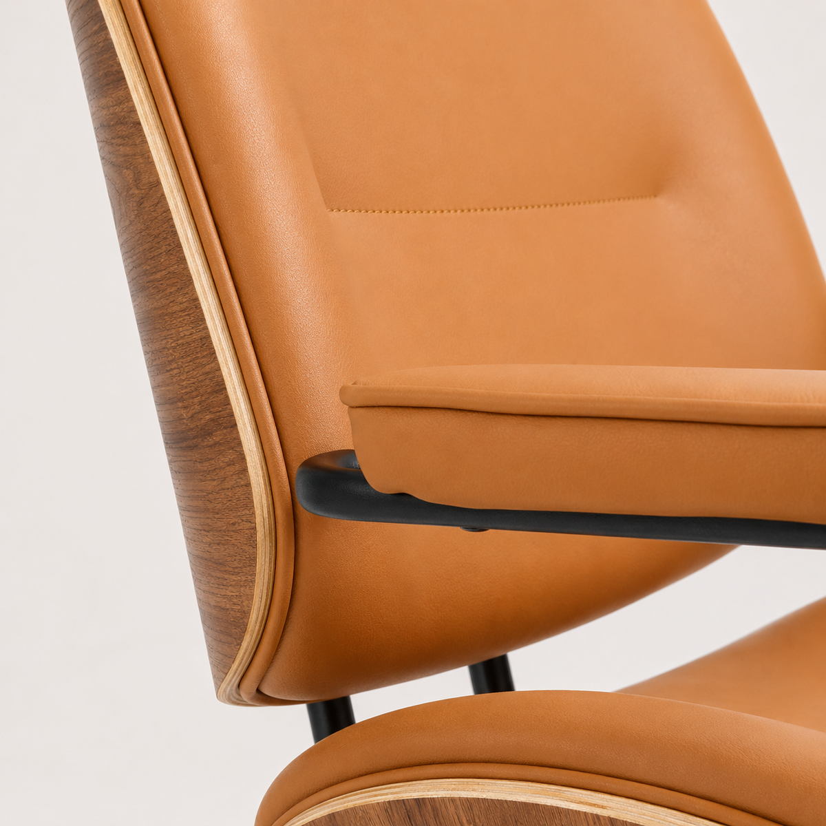 Orange faux leather upholstery and padded armrests on The Calder Office Chair