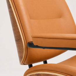 Orange faux leather upholstery and padded armrests on The Calder Office Chair