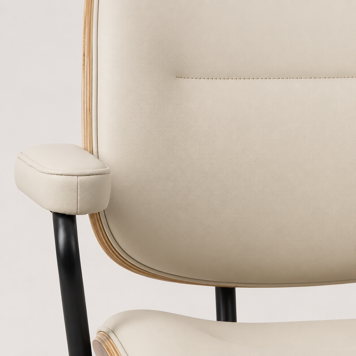 Beige faux leather upholstery and integrated armrests on The Calder Office Chair