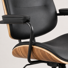 Black faux leather upholstery and integrated armrests on The Calder Office Chair