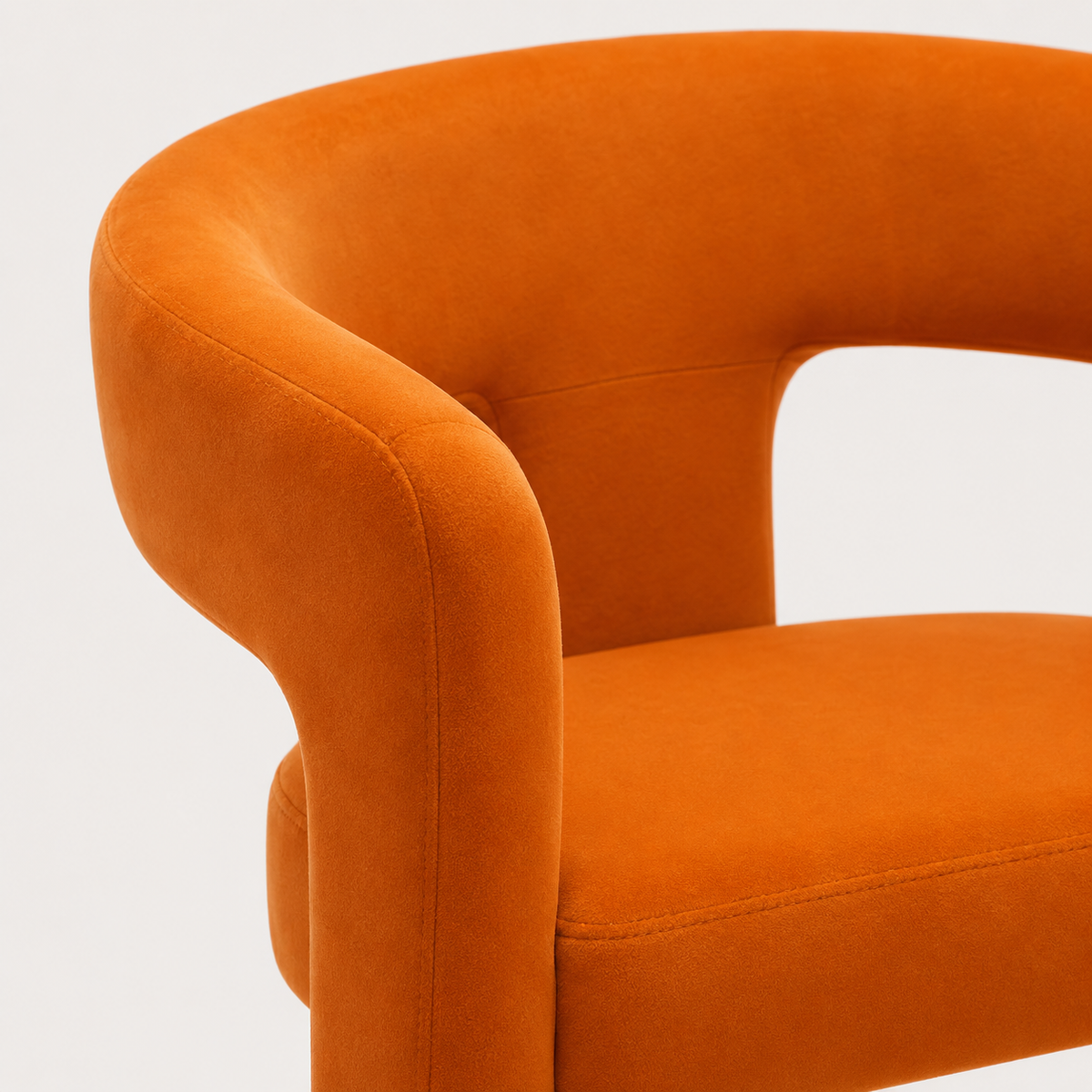 Close view of the ember-orange velvet and high-density foam seat