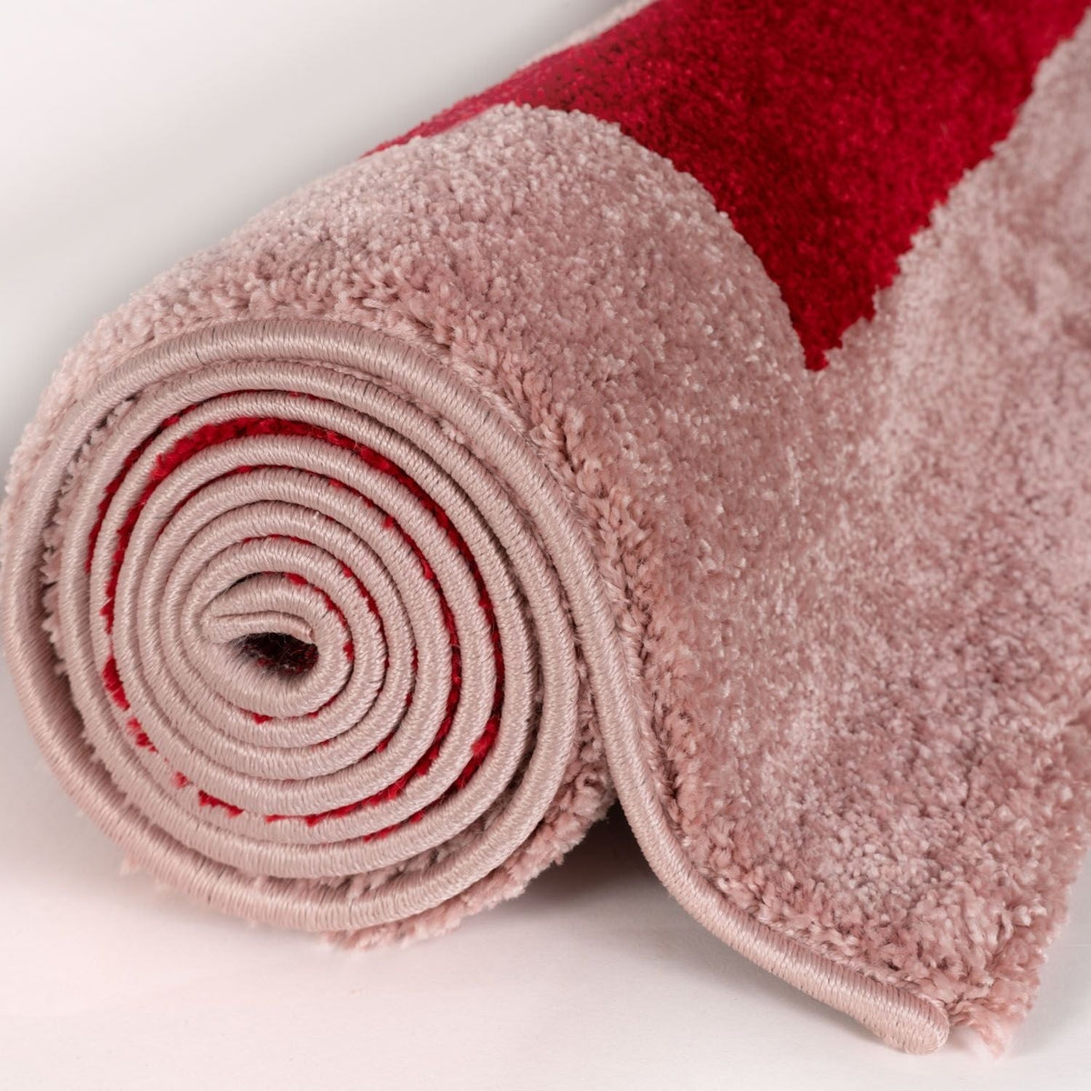Cherry Maze Rug — rolled side view