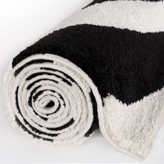 Mono Ripple Rug — rolled side view