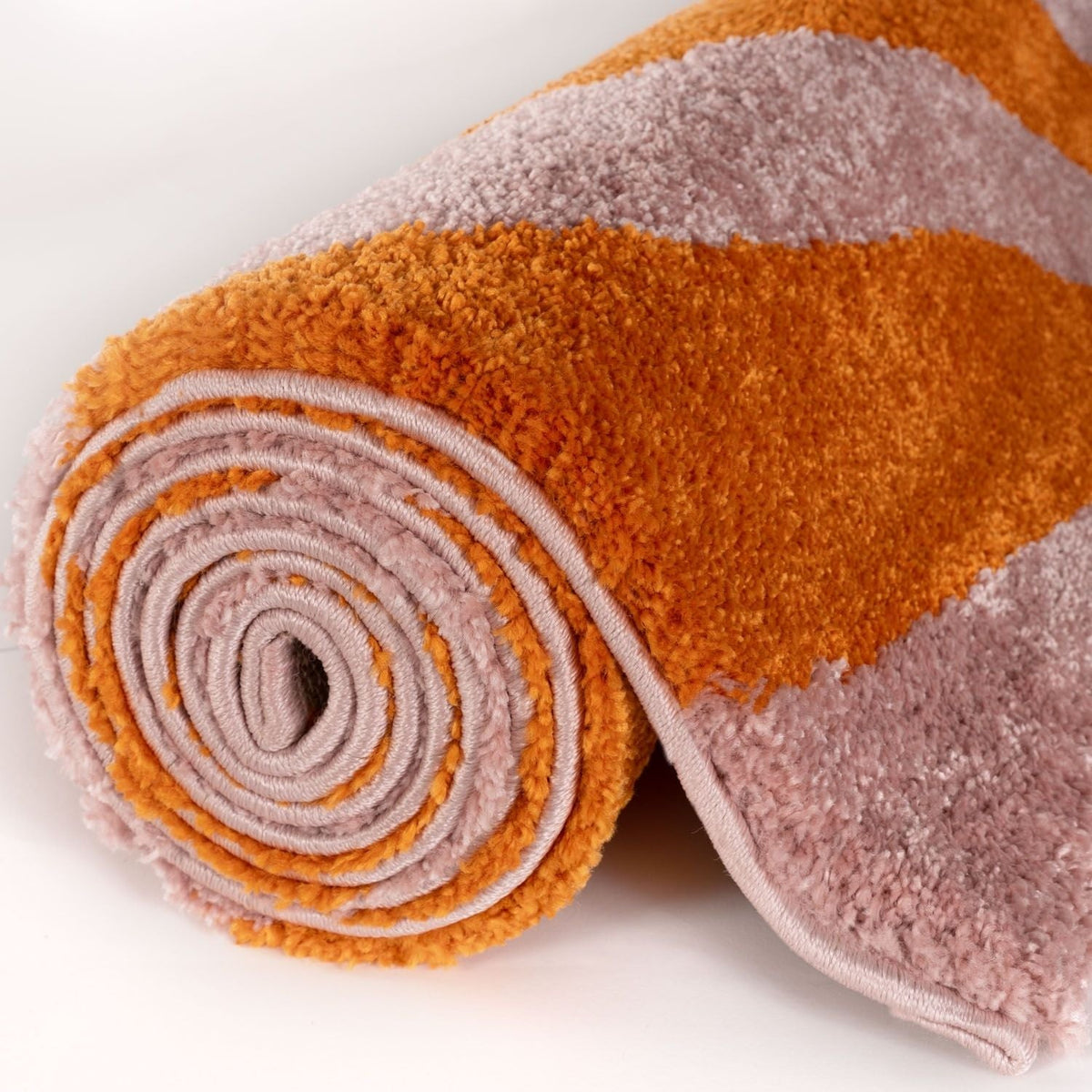 Sunset Ripple Rug — rolled side view