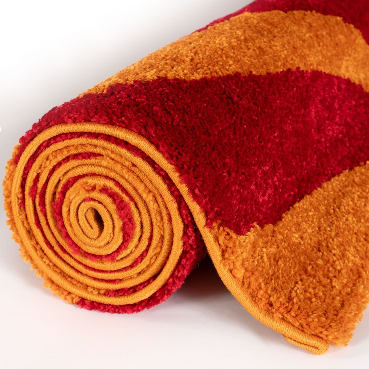 Ember Stripe Rug — rolled side view