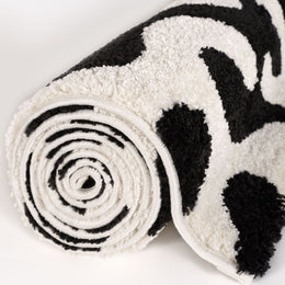 Ink Scribble Rug — rolled side view