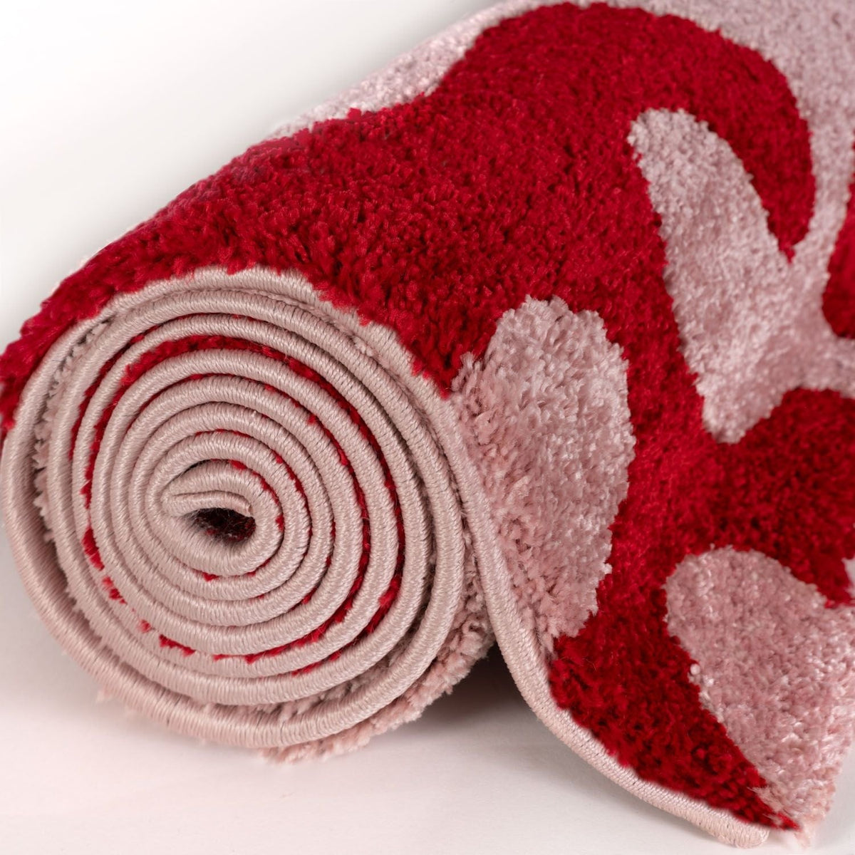 Cherry Scribble Rug — rolled side view