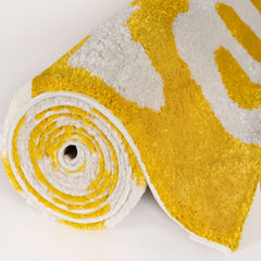 Lemon Scribble Rug — rolled side view