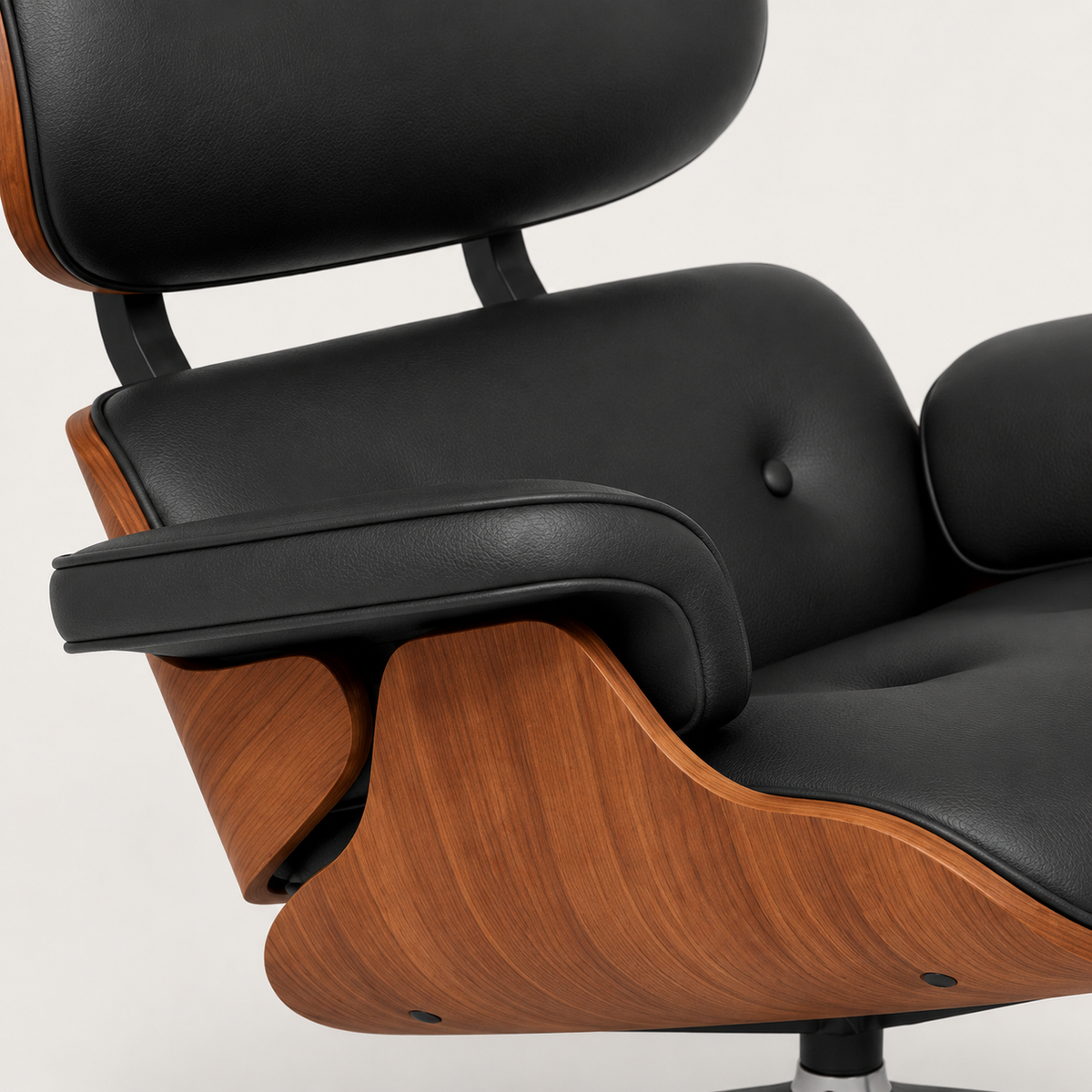 Close view of the chair's buttoned black leather-look upholstery