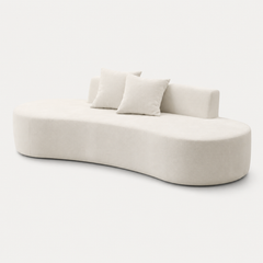 Curved profile and low backrest of The Mallow Chaise Sofa in Beige