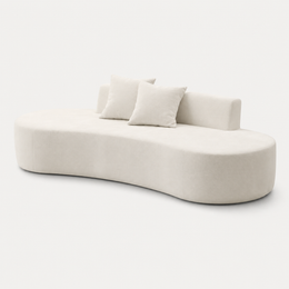 Curved profile and low backrest of The Mallow Chaise Sofa in Beige