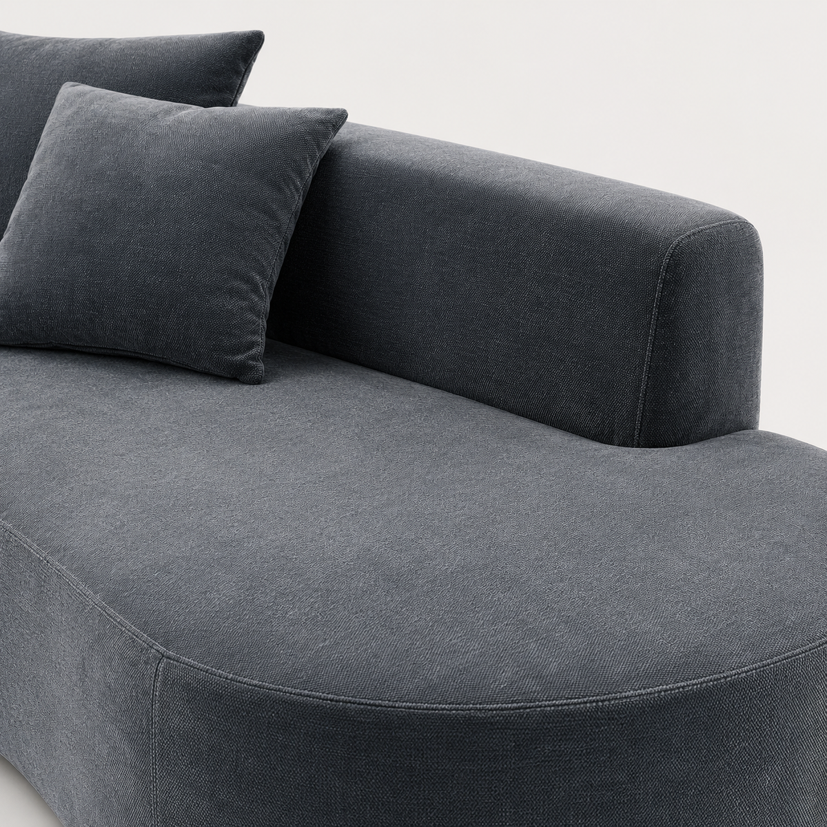 Curved profile and low backrest of The Mallow Chaise Sofa in Midnight Blue