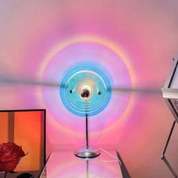 Sunset projection lamp casting circular colour on a wall