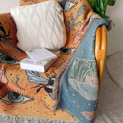 Orange woven throw styled across interior furniture