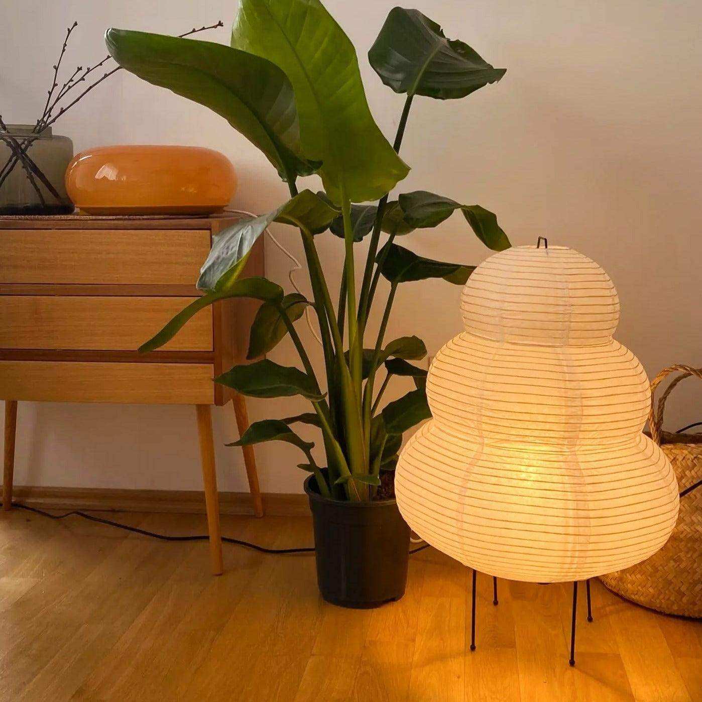Sculptural paper table lamp with slim black tripod base