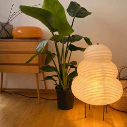 Sculptural paper table lamp with slim black tripod base
