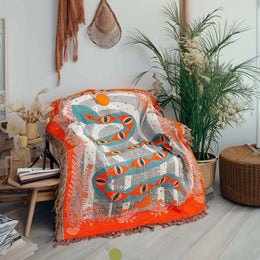 Serpent woven throw styled as graphic indoor wall decor