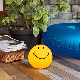 USB-charging smiley face lamp with portable glow