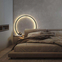 Modern ring wall light casting diffused light across the wall