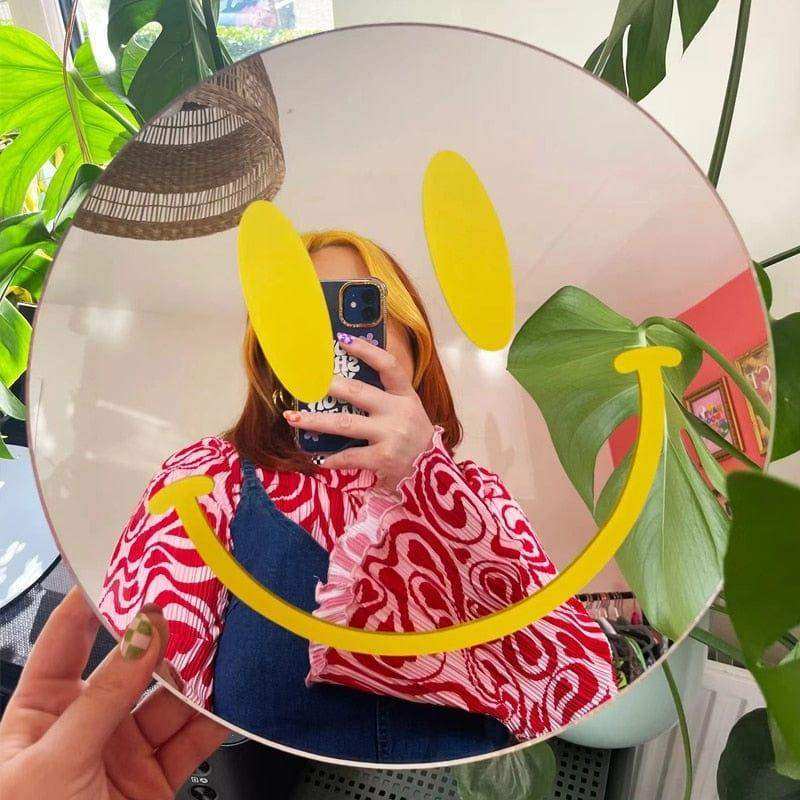 Person taking a mirror photo in the yellow Smiling Reflections Mirror